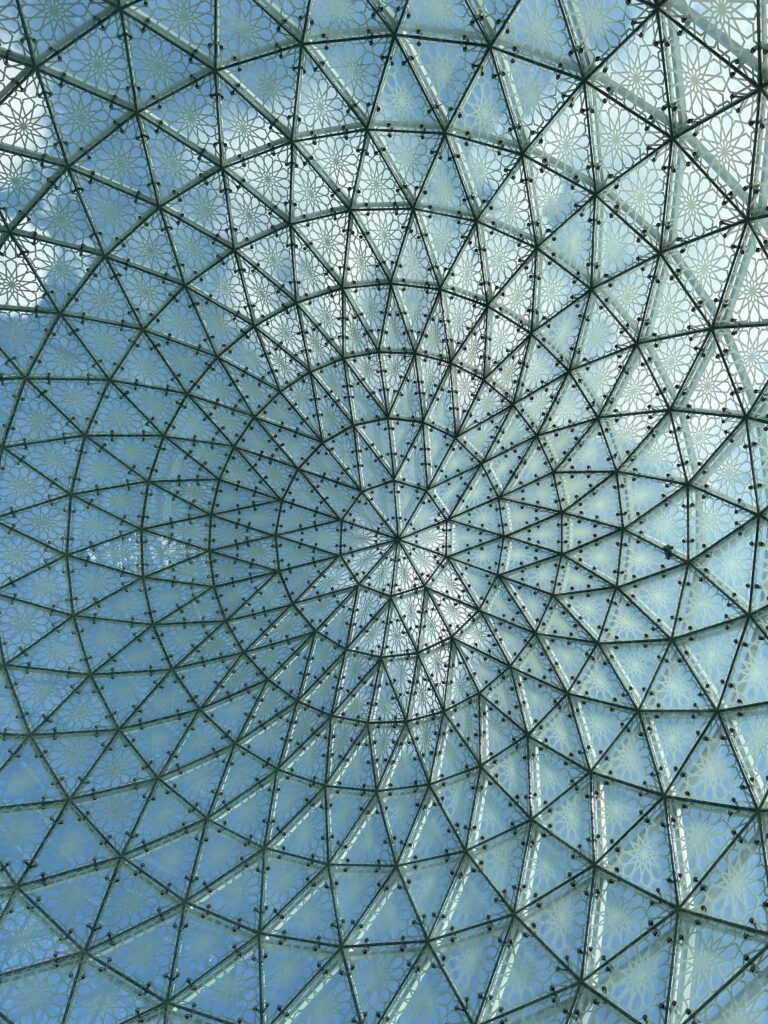 Modern glass dome ceiling with geometric patterns in Abu Dhabi, UAE.